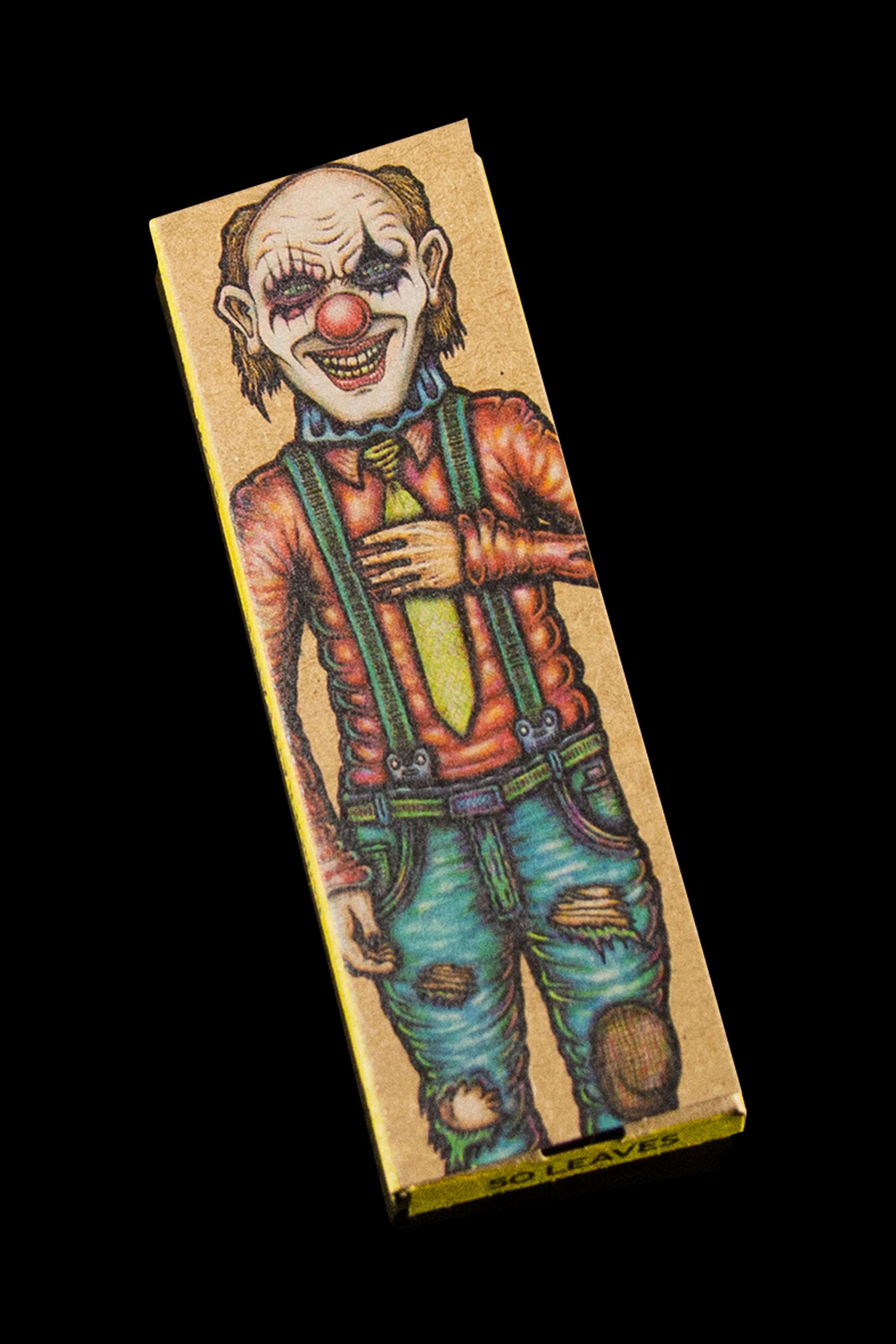 A rectangular, patterned rolling paper booklet featuring a darkly illustrated, menacing clown in overalls.