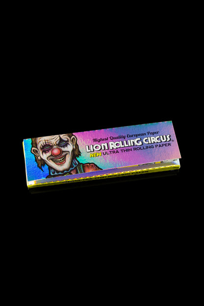 Pack of Lion Rolling Circus ultra-thin rolling papers with a colorful clown design on a black background.