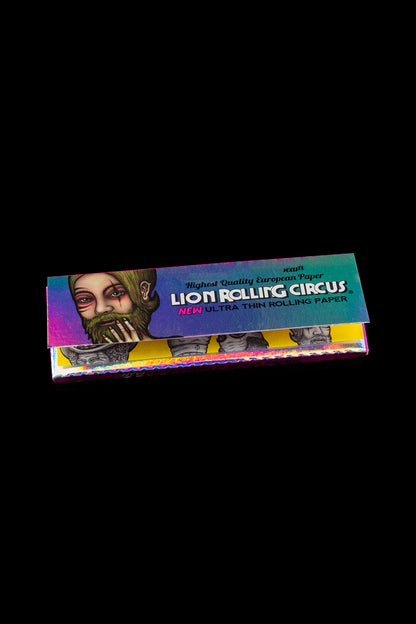 Package of Lion Rolling Circus ultra-thin rolling papers with a stylized portrait of a bearded man on a dark background.