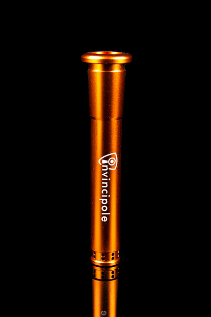 Orange cannabis oil applicator with "Invincipole" logo against a black background.