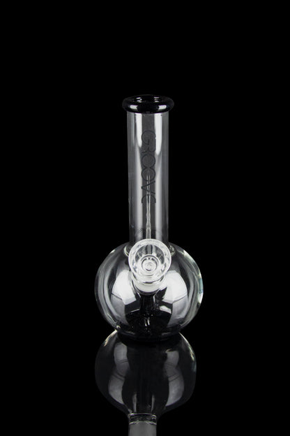 Clear glass bubbler water pipe with branding, isolated on black.