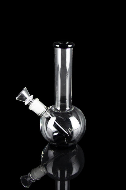 Clear glass bubbler water pipe with a flared mouthpiece, isolated on black.