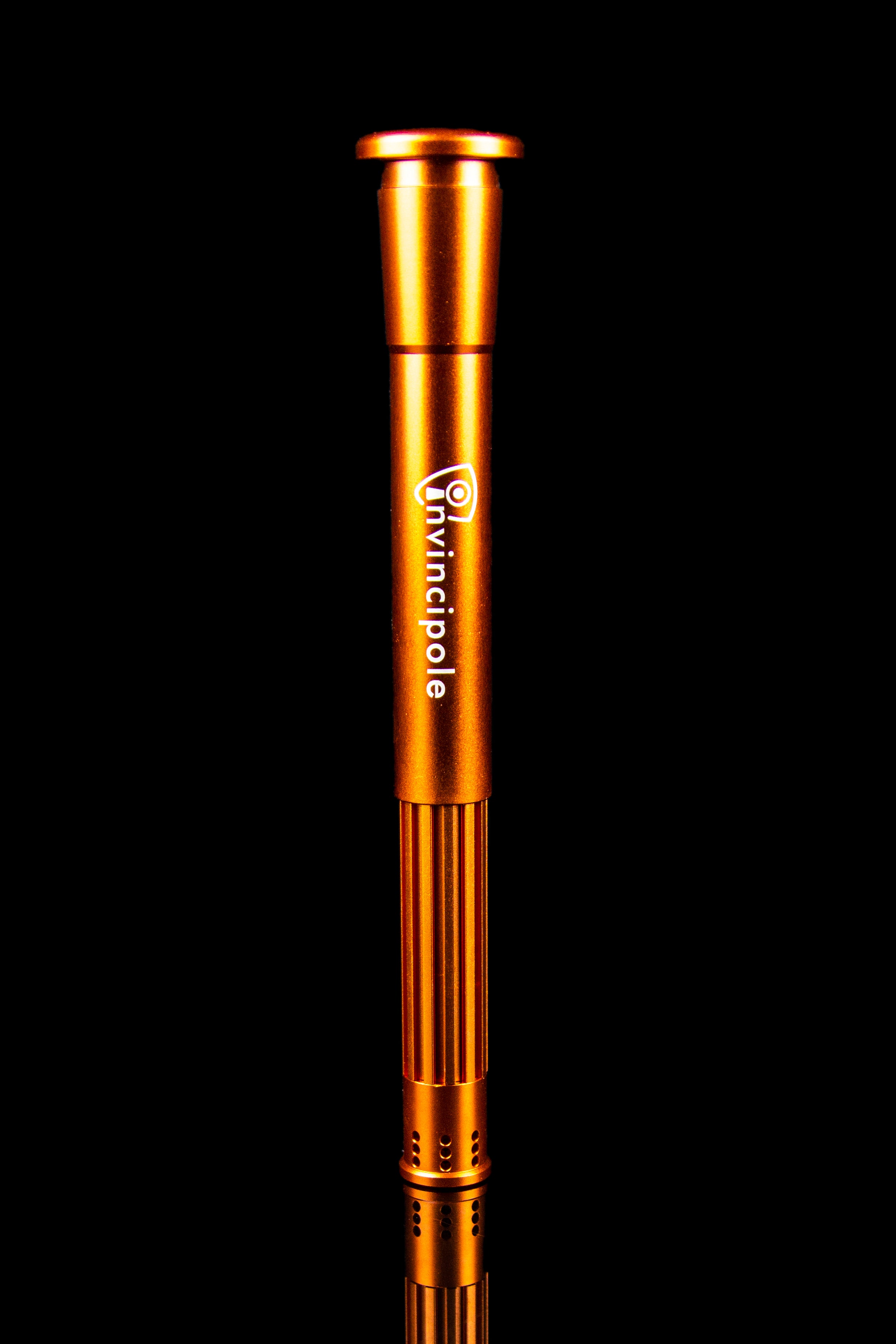 Orange metallic oil burner pipe with "Invincipole" logo against a black background.
