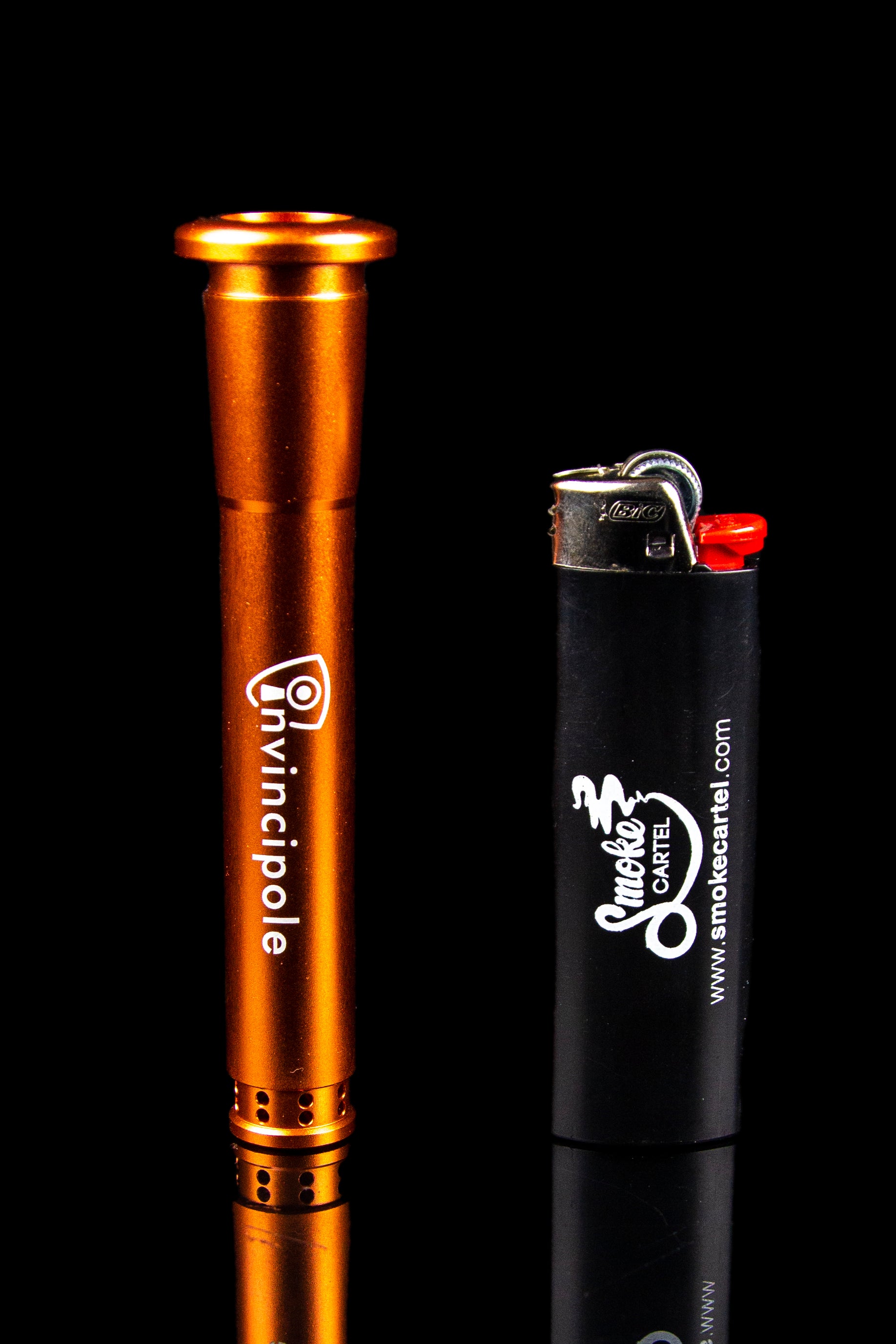 Orange oil rig and black lighter with cannabis branding, studio shot.