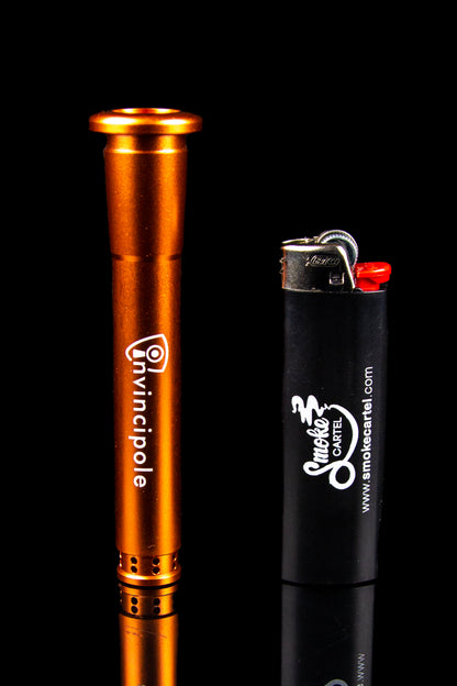 Orange oil rig and black lighter with cannabis branding, studio shot.