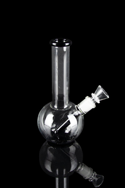 Clear glass bubbler water pipe with a flared mouthpiece, isolated on black.