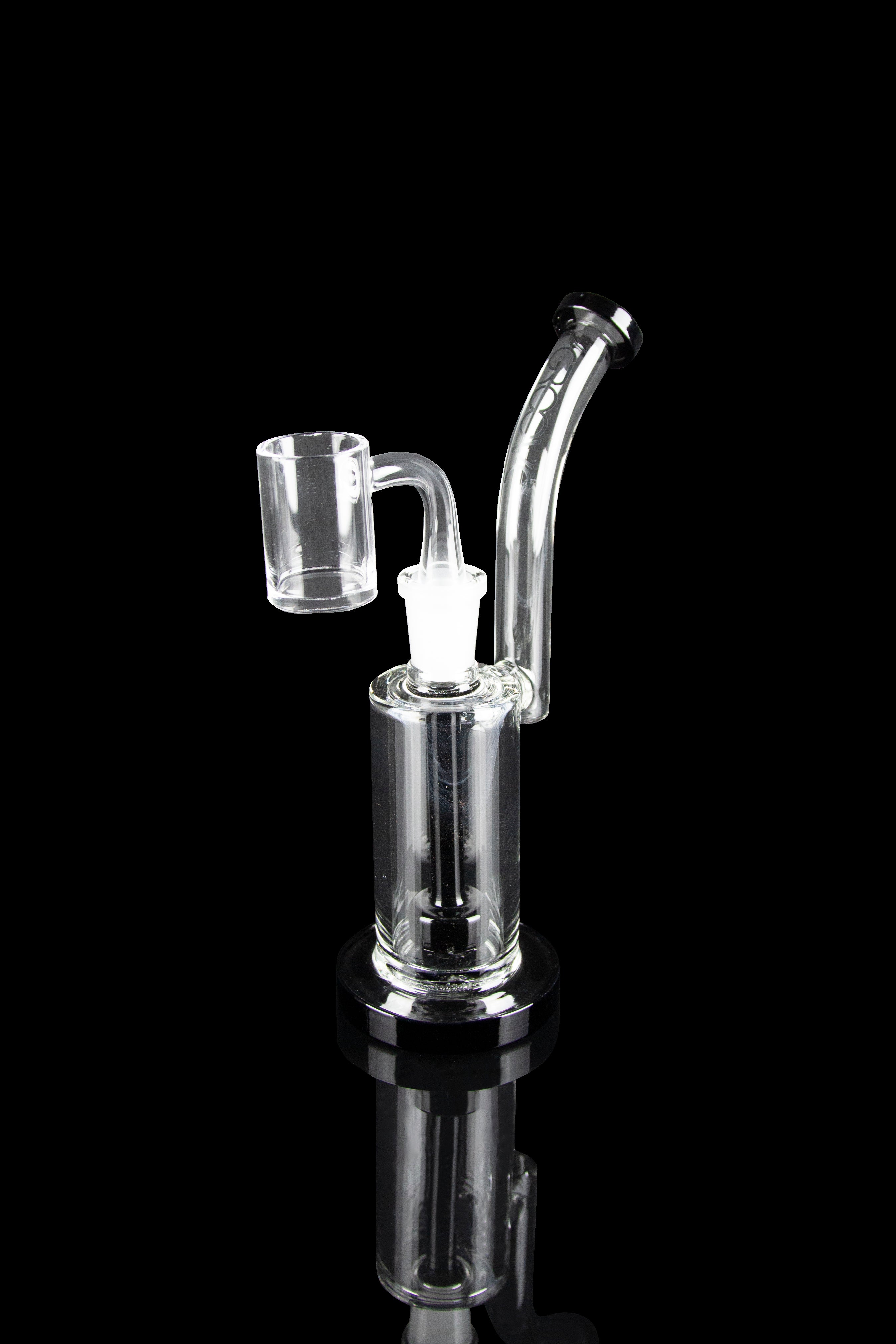 Clear glass dab rig with a quartz banger, isolated on a black reflective surface.