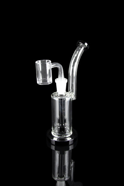 Clear glass dab rig with a quartz banger, isolated on a black reflective surface.