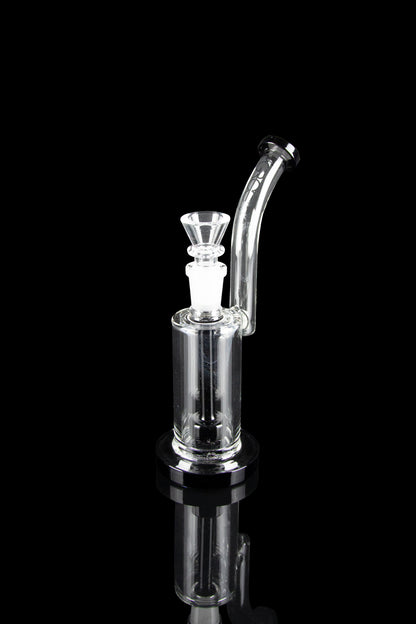 Clear glass bubbler with a bowl piece, reflecting on a black surface.