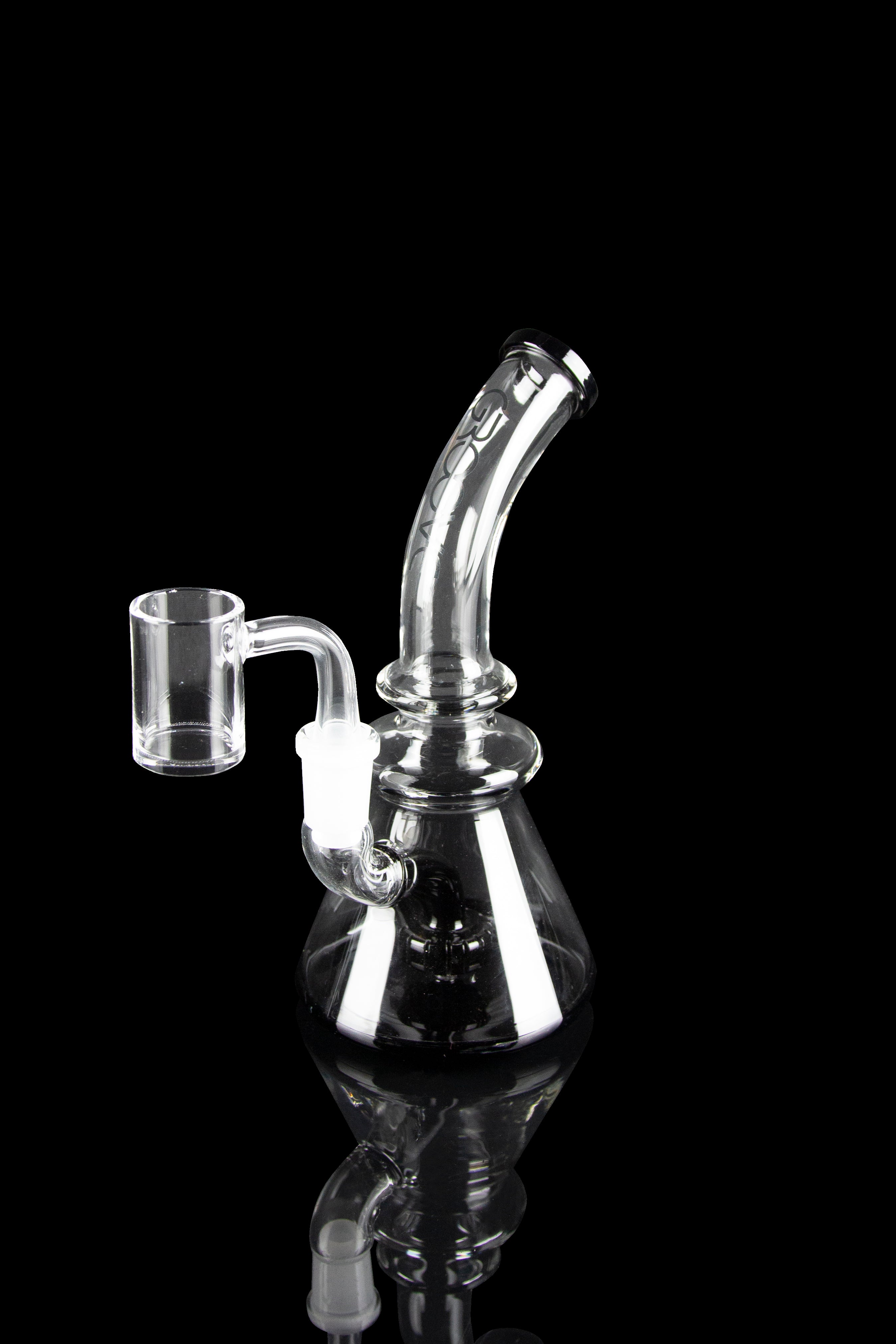 Clear glass dab rig with quartz banger, isolated on black.