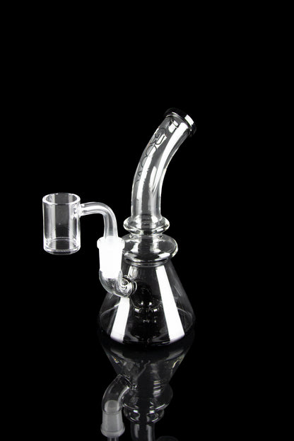 Clear glass dab rig with quartz banger, isolated on black.