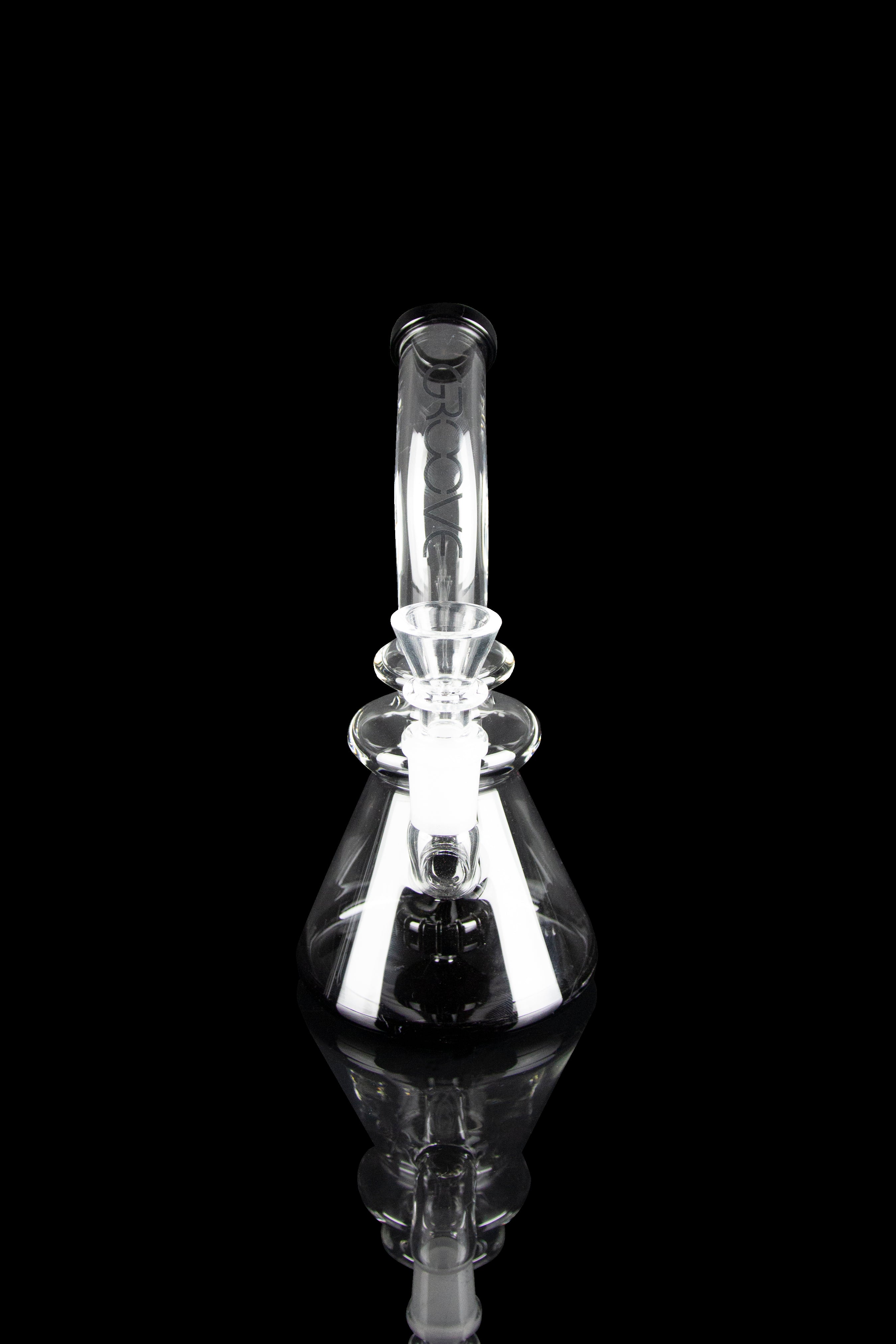 Clear glass water pipe (rig) with intricate bubbler design, emitting visible vapor, against a black background.