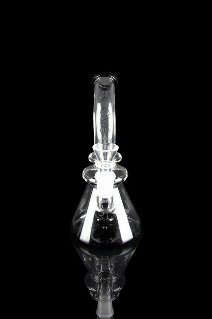 Clear glass water pipe (rig) with intricate bubbler design, emitting visible vapor, against a black background.