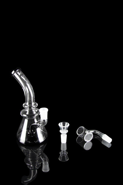 Clear glass dab rig with accessories on a black background.