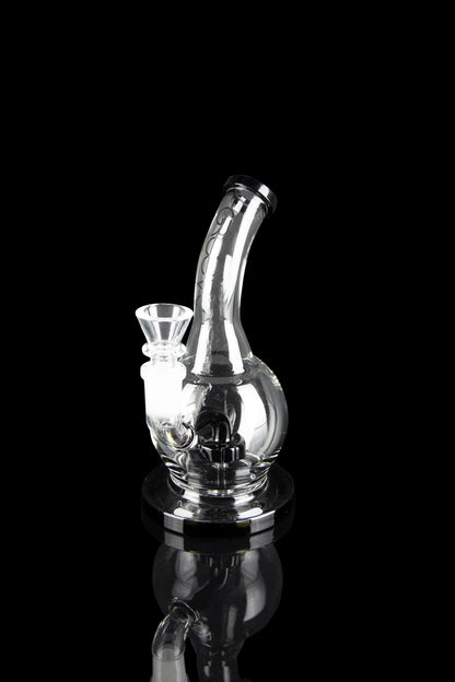 Clear glass water pipe (rig) with intricate bubbler design, isolated on black.