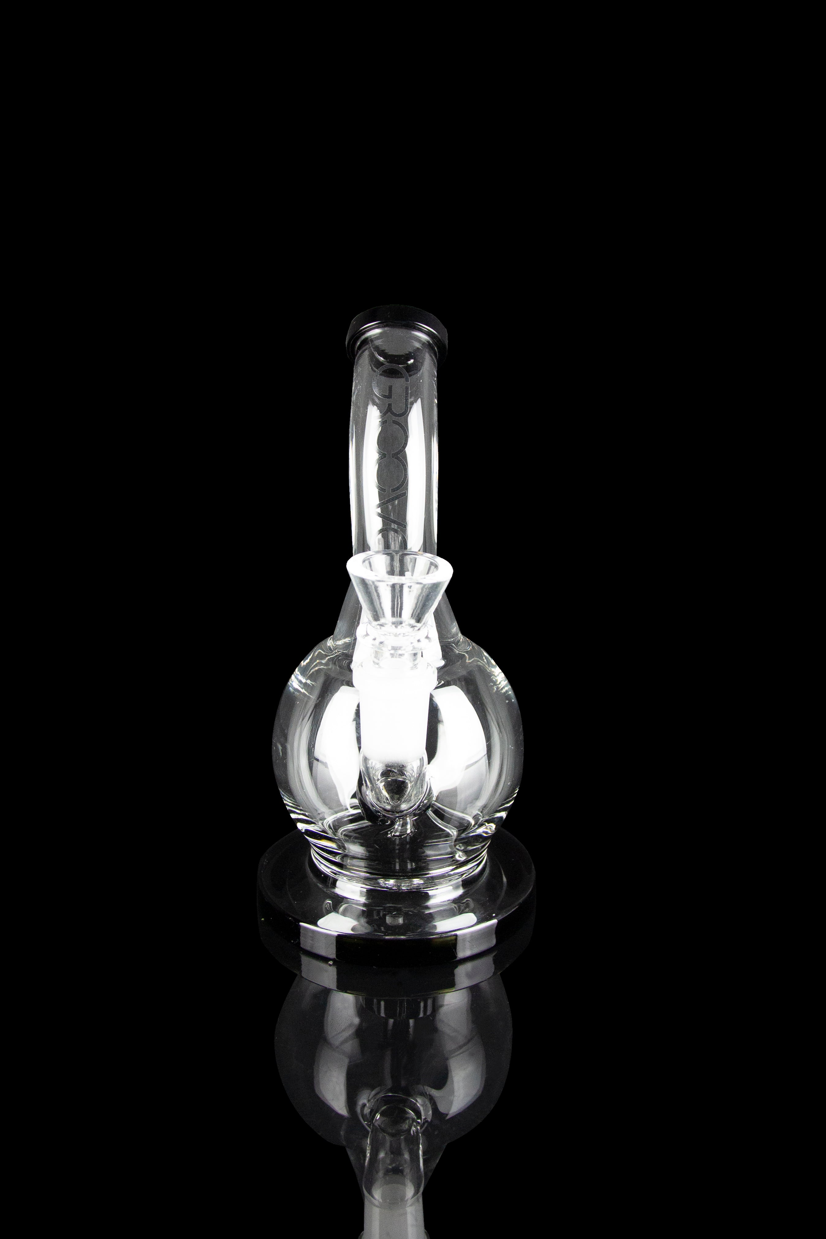 Clear glass dab rig with illuminated internal chamber, isolated on black.
