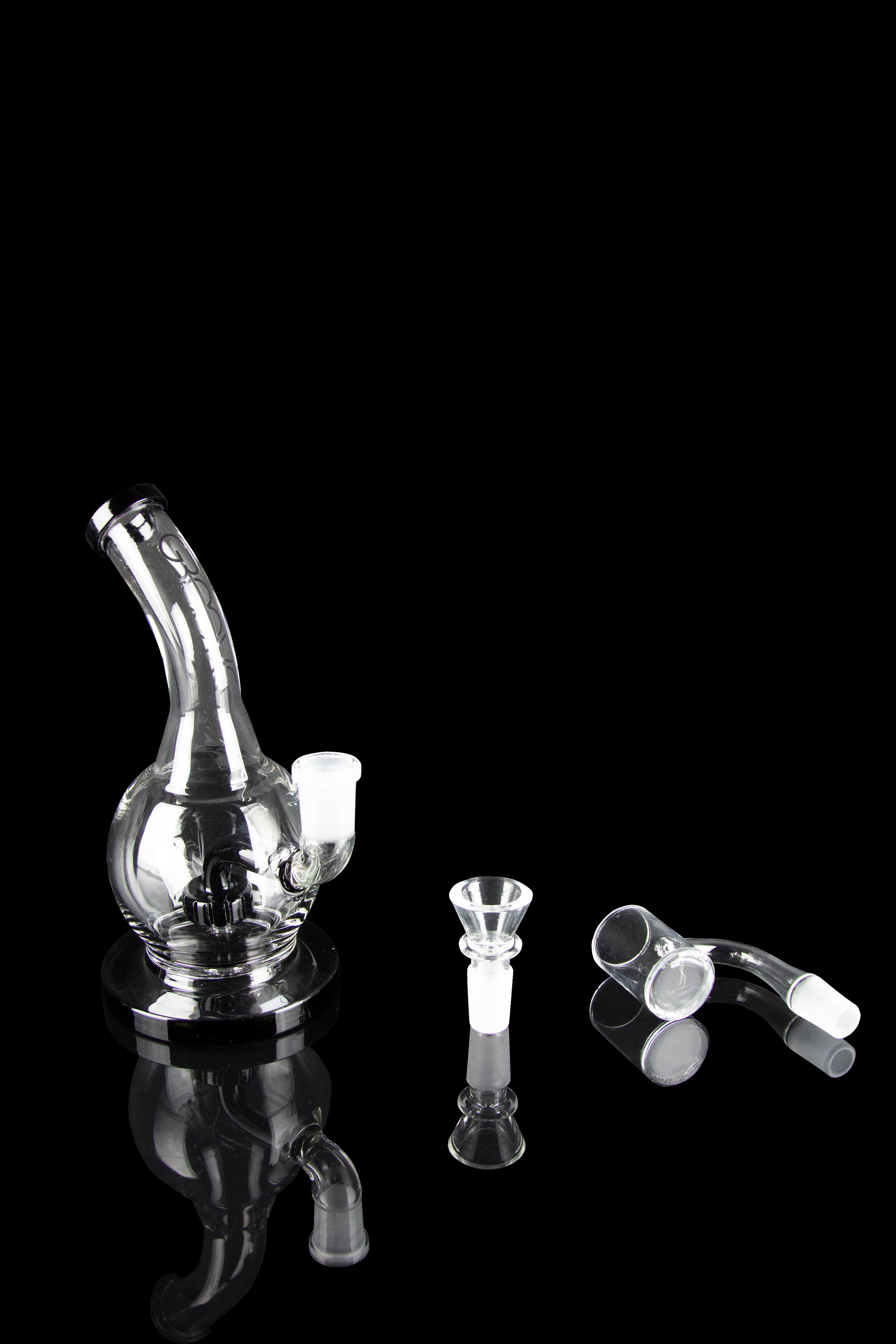 Clear glass bubbler water pipe and cannabis smoking accessories displayed on a black background.