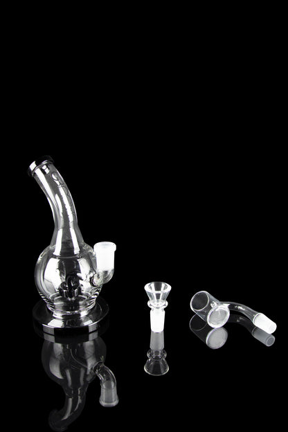 Clear glass bubbler water pipe and cannabis smoking accessories displayed on a black background.