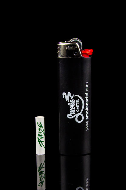 Black lighter with “Smoke Cartel” branding and graffiti-style writing alongside it.