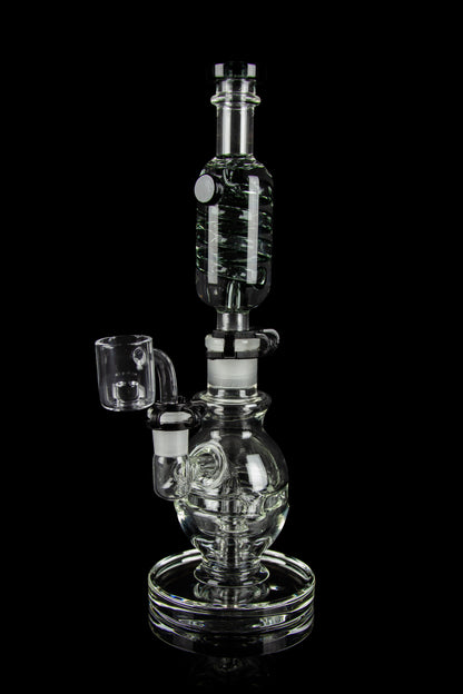 Clear glass water pipe (rig) with a quartz banger, isolated on a black background.