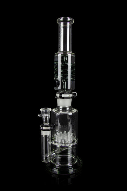Clear glass water pipe (bong) with intricate percolator diffusion system, displayed against a black background.