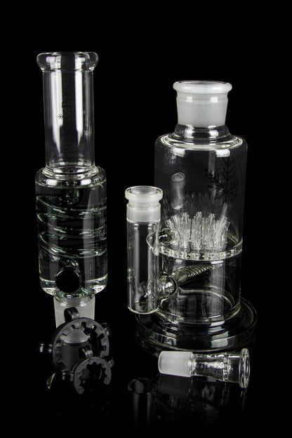 Clear glass water pipes and attachments on a black background.