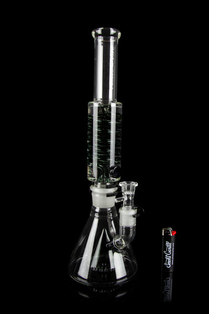 Glass bong with black and white striped percolator, isolated on a black background.