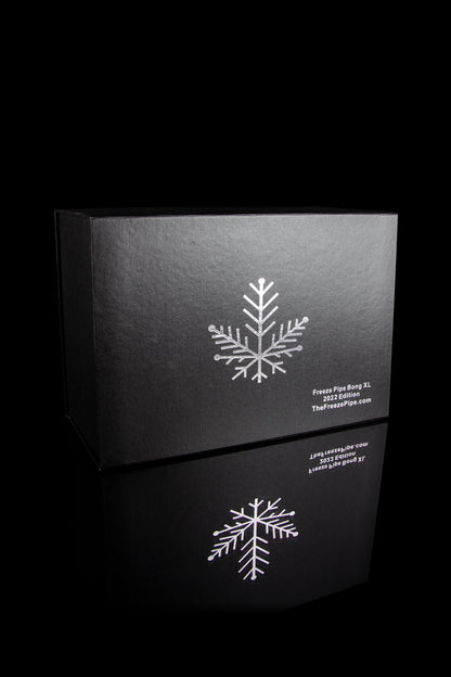 Black box with white snowflake design and text indicating “Freeze Pipe Bong XL 2022 Edition” and website address.