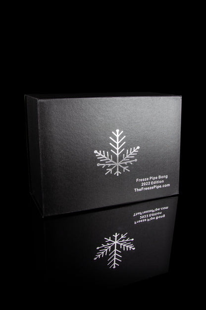 Black box for a cannabis accessory, featuring a white snowflake design and text reading “Freeze Pipe Bong 2022 Edition” and website address.