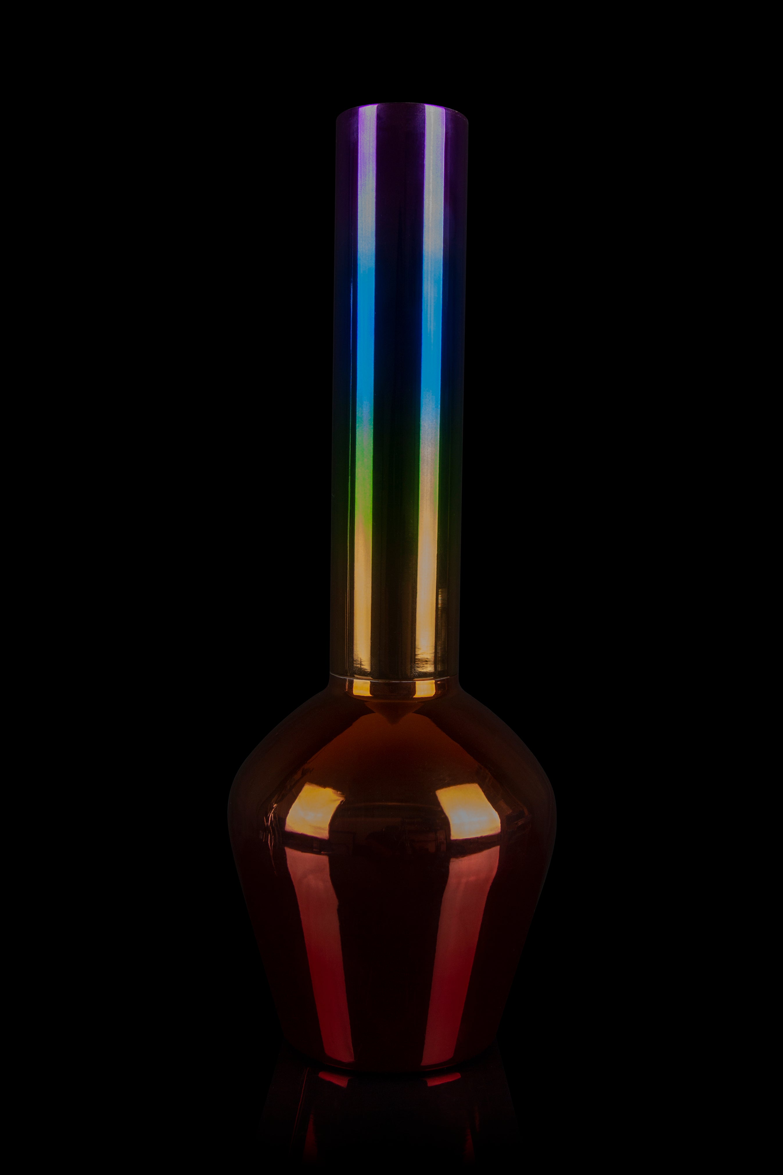 A colorful glass bong against a black background.