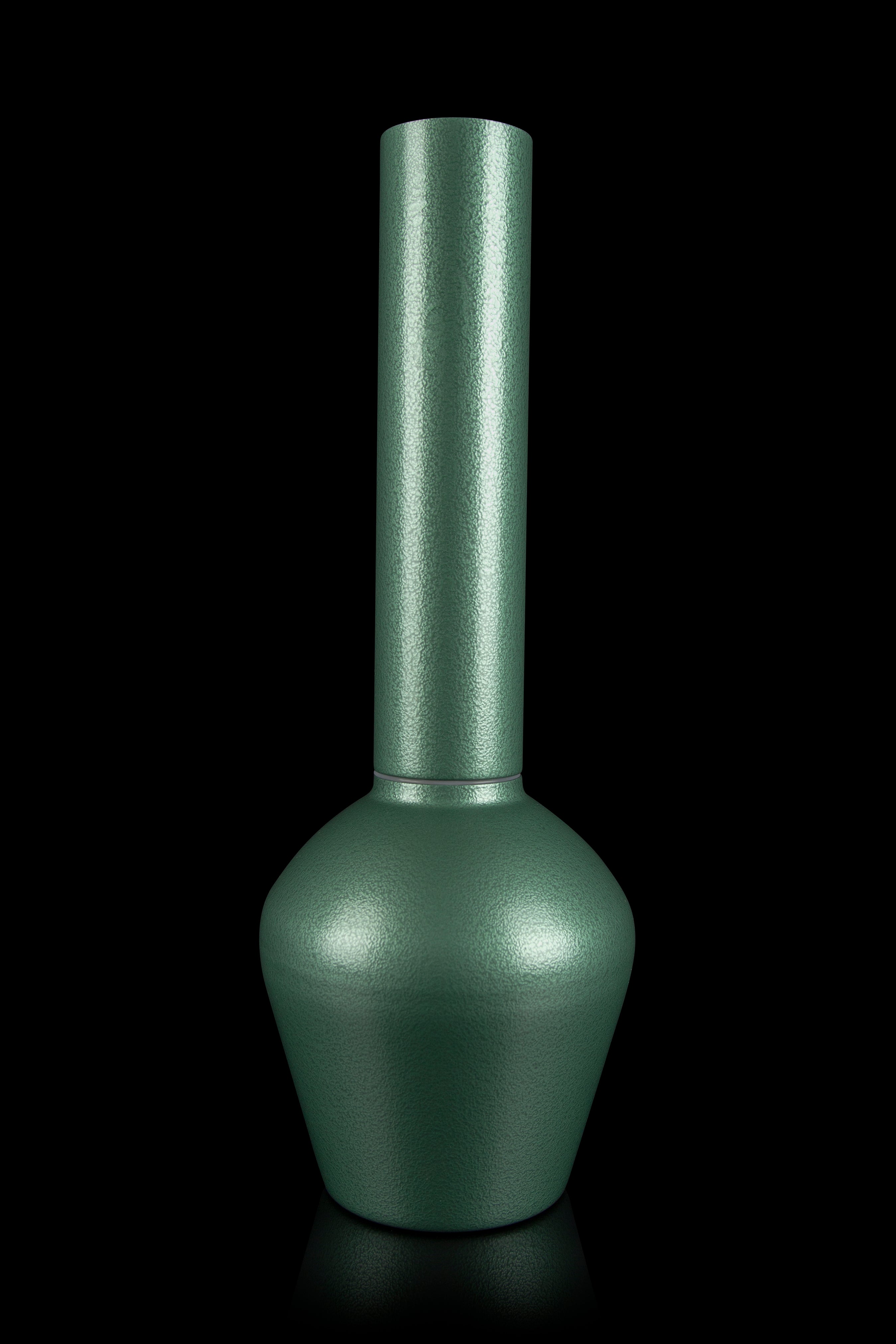 Emerald green glass cannabis water pipe against a black background.