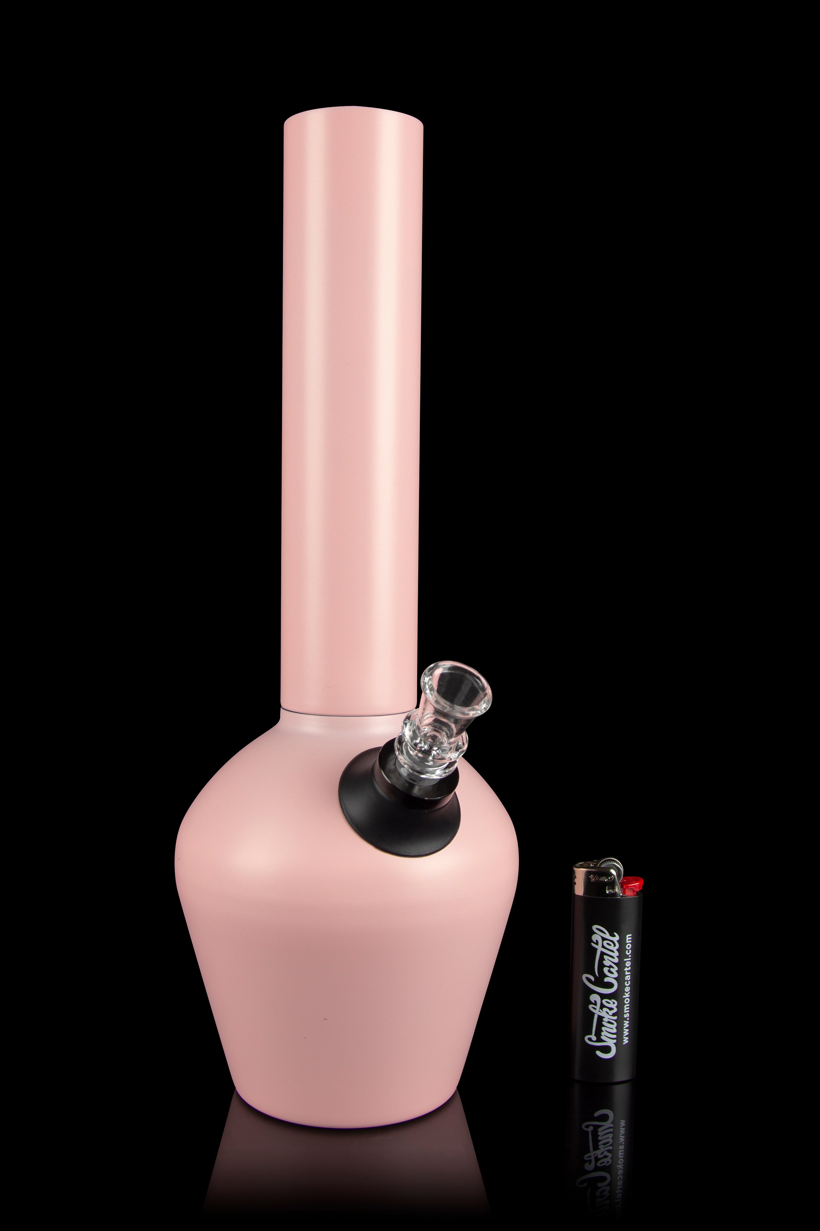 Pink glass water pipe (bong) with a flared base and ice catcher, displayed on a reflective surface.
