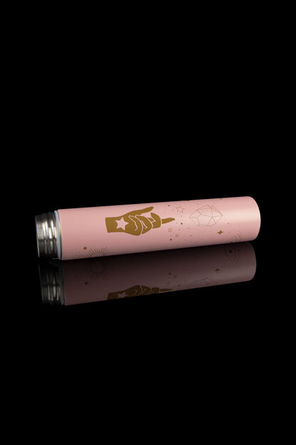 Pink cannabis preroll tube with gold celestial designs and reflective surface, isolated on black.