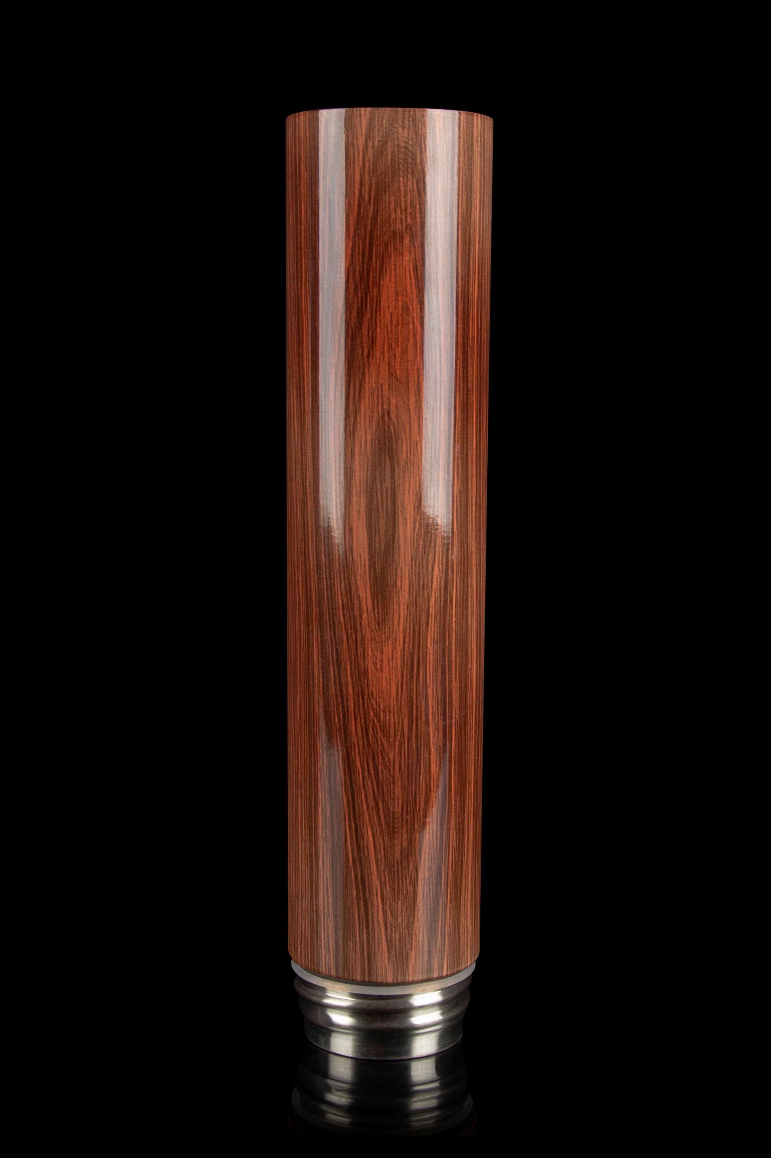 Polished wood bubbler or water pipe stem against a black background.