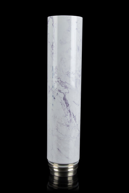 Marble-patterned glass bubbler with metallic base, isolated on black.