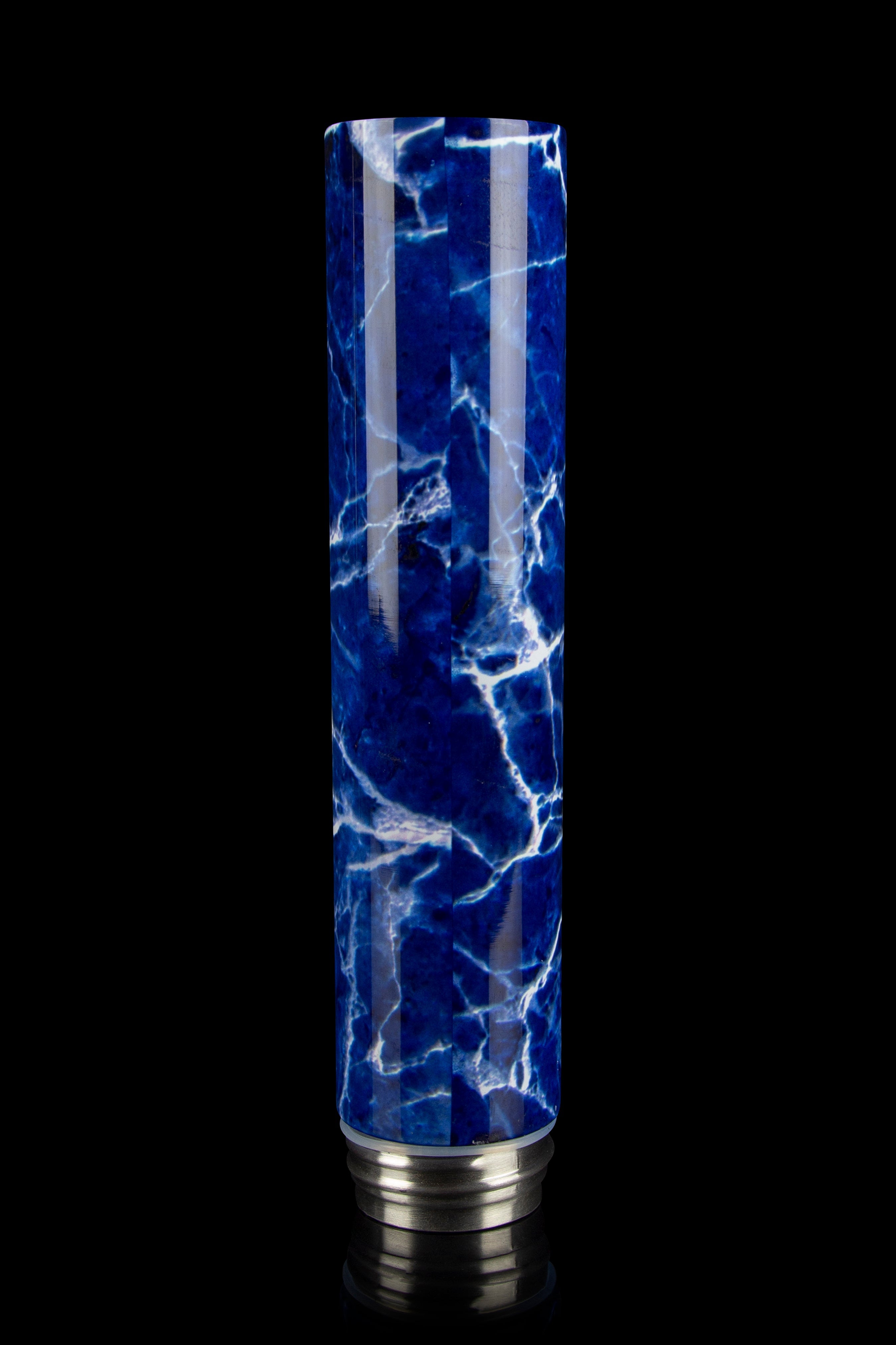 Blue marbled glass bubbler with silver base, isolated on black.