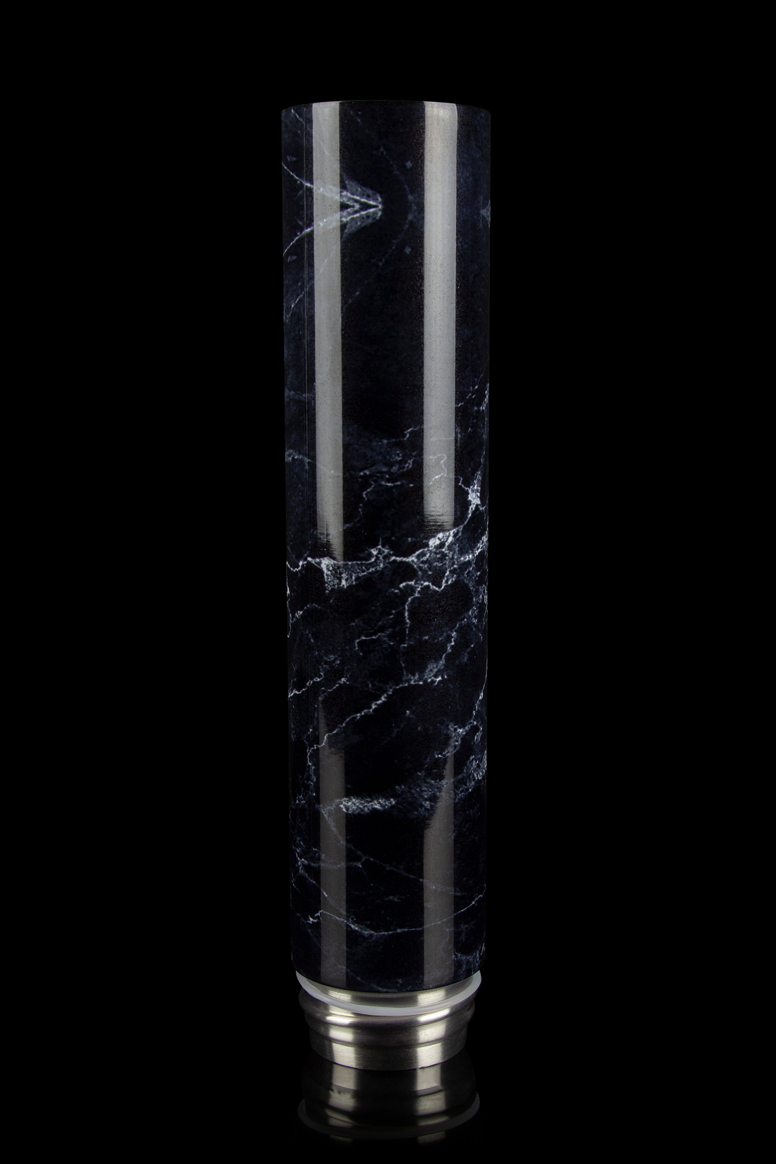 Black and white marbled glass water pipe with a silver base, isolated on a black background.