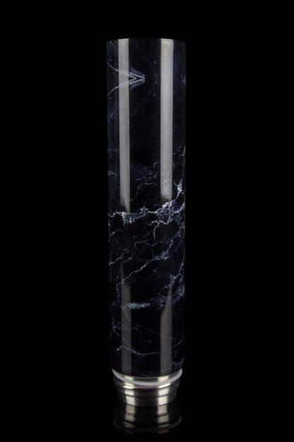 Black and white marbled glass water pipe with a silver base, isolated on a black background.