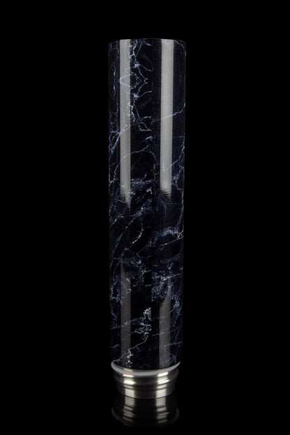 Black and white marbled glass cannabis water pipe (bubbler) with silver accents, isolated on a black background.