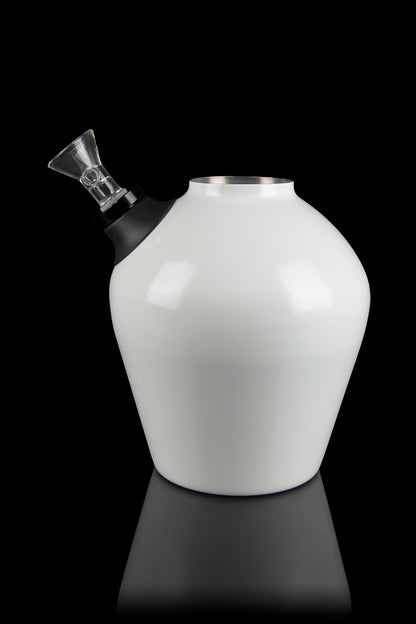 White glass water pipe with a black mouthpiece and clear glass downstem, studio shot on a reflective surface.