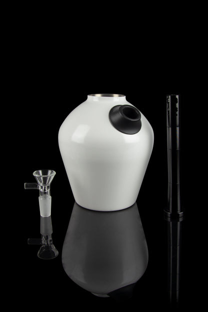 White glass water pipe with a downstem and tool, studio shot on a black reflective surface.