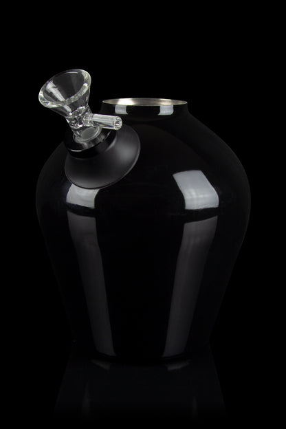 Black cannabis vaporizer with a glass mouthpiece, studio shot.