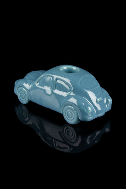 Teal glass pipe shaped like a classic car with a reflective black surface.