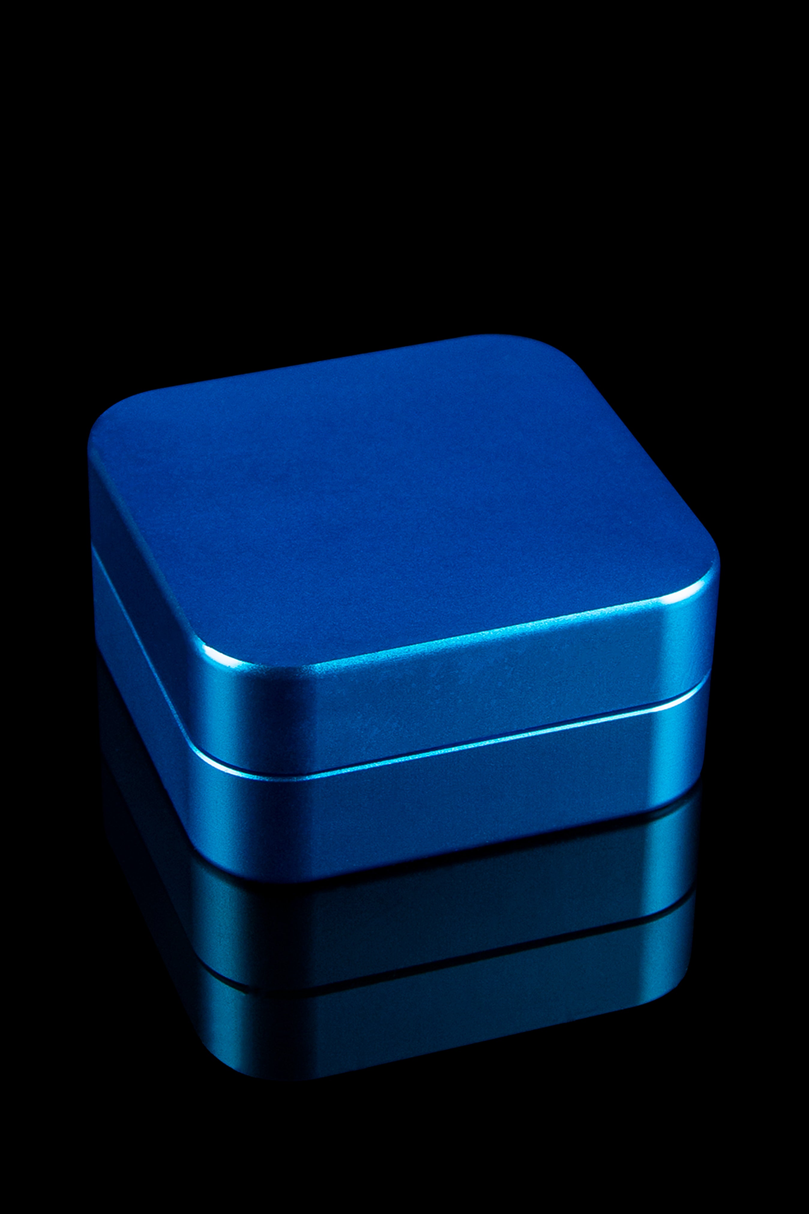 Blue metal storage box, likely for cannabis or accessories, with a glossy finish and reflective surface.