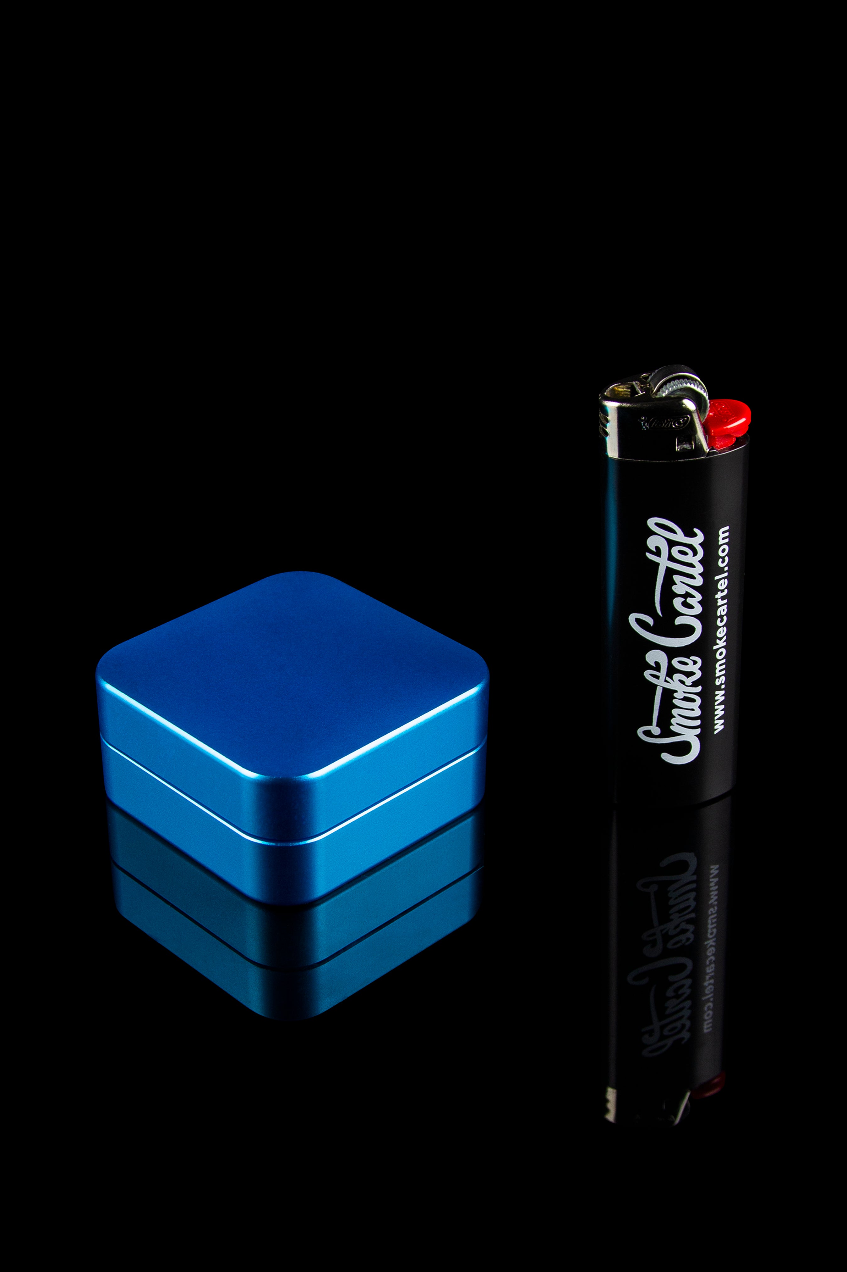 Blue stash box stacked next to a branded lighter on a black background.