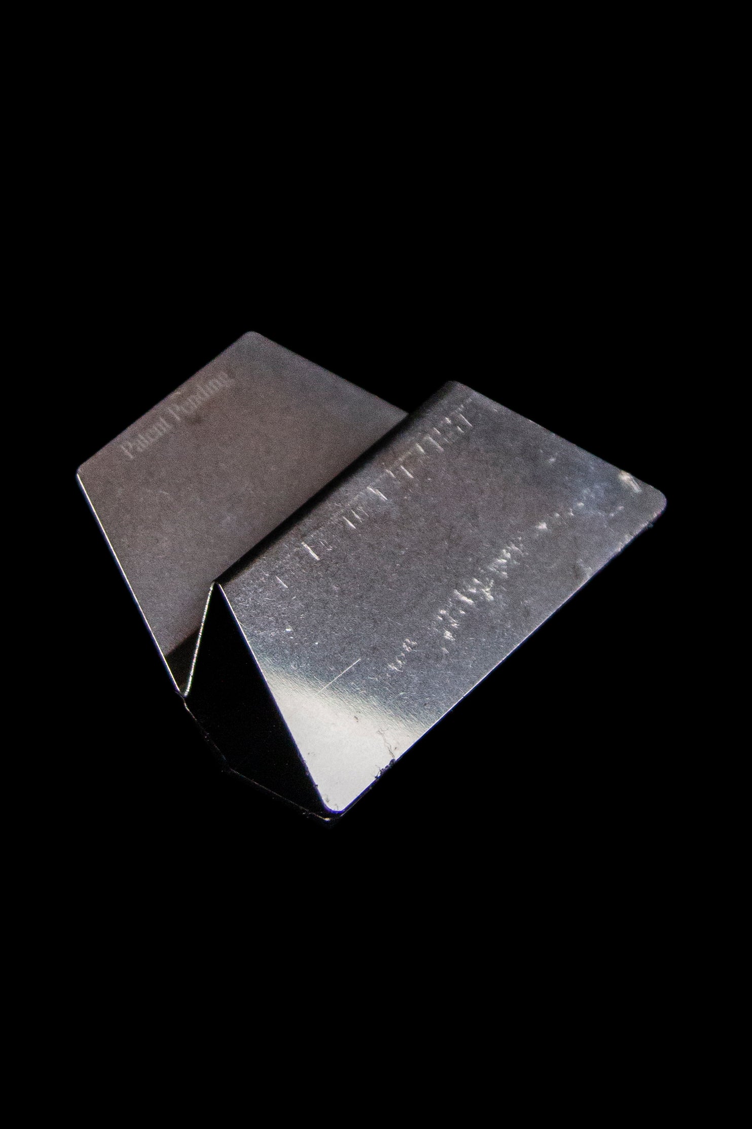 Black magnetic cannabis storage box on a dark background.