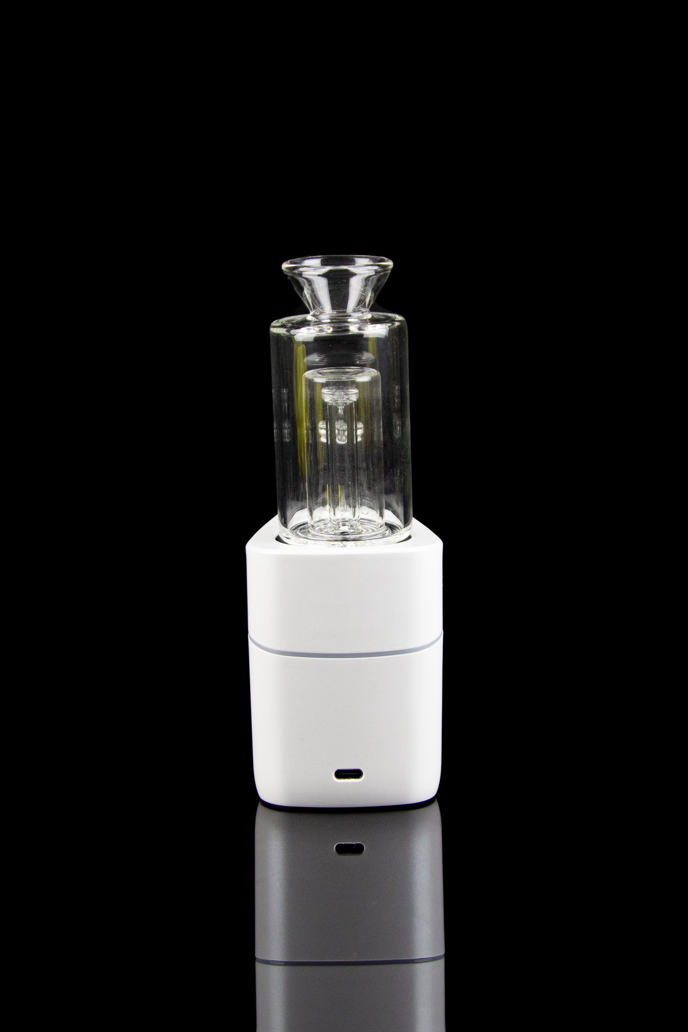 White cannabis e-rig with a glass bubbler, displayed on a reflective surface against a black background.