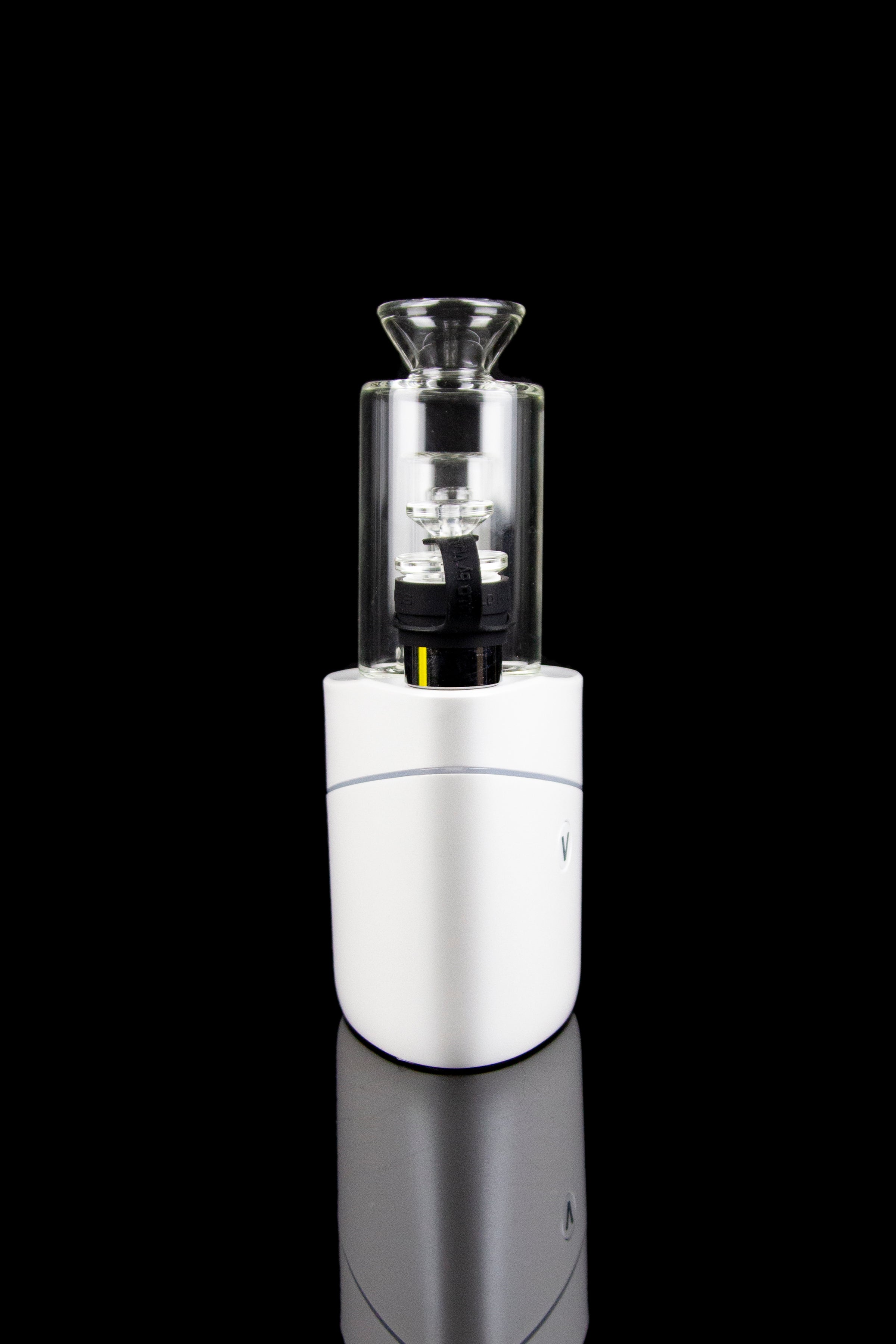 Silver and glass cannabis e-rig vaporizer with a glossy black reflective surface.
