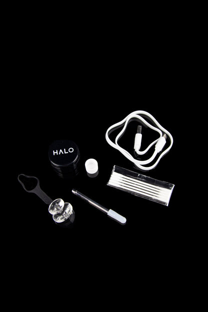 Cannabis vaporization device and accessories on a black background.