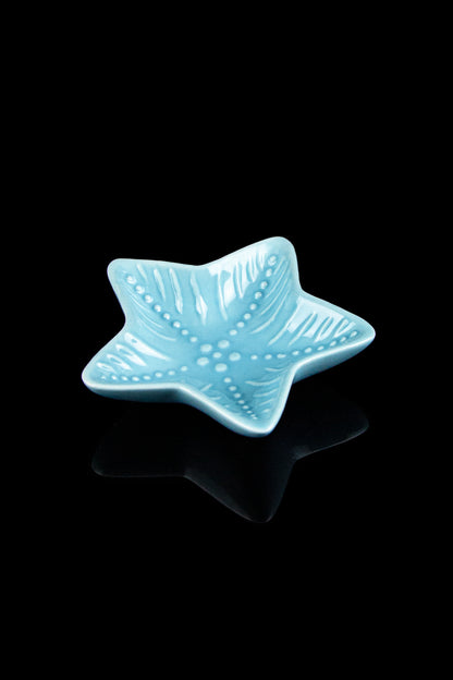 Ceramic teal star-shaped ashtray with a glossy finish.